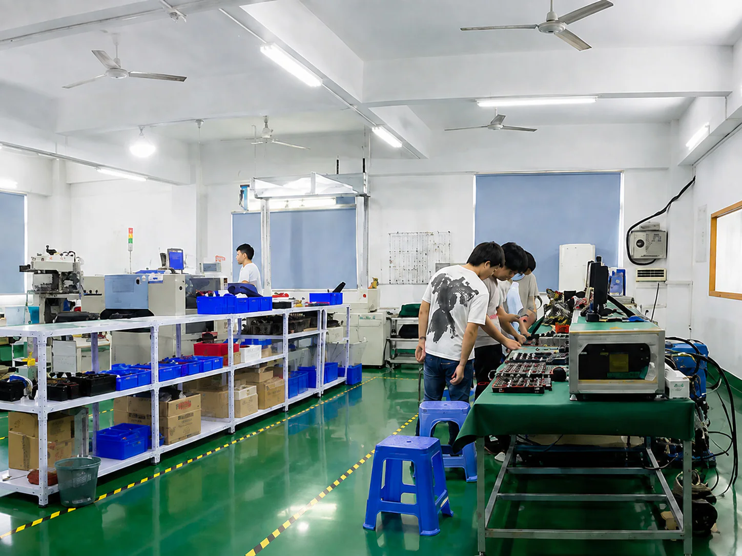 Technicians following a standardized transmitter assembly process